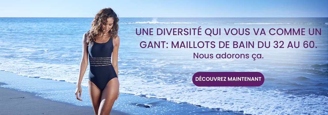 Une diversité qui vous va comme un gant – Femme en maillot de bain une pièce sombre marchant sur la plage