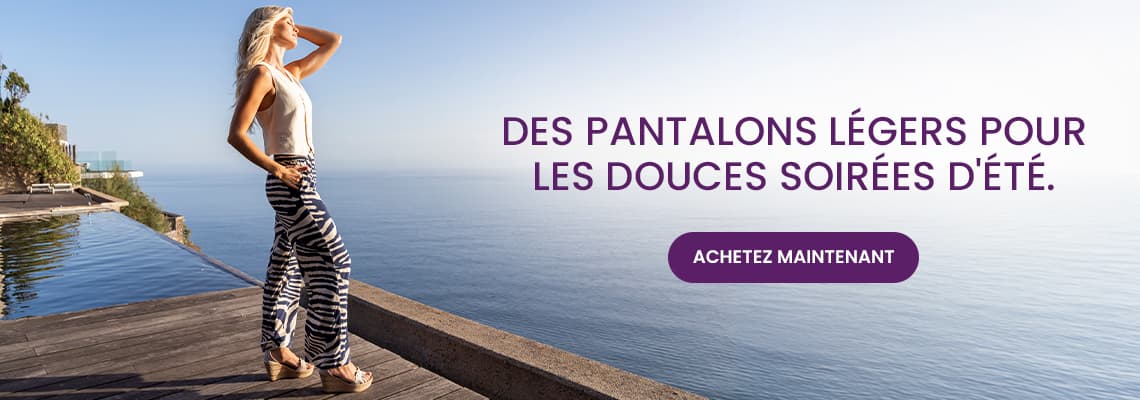 Des pantalons légers pour les douces soirées d’été – Personne debout en pantalon à motifs près d’une piscine face à la mer